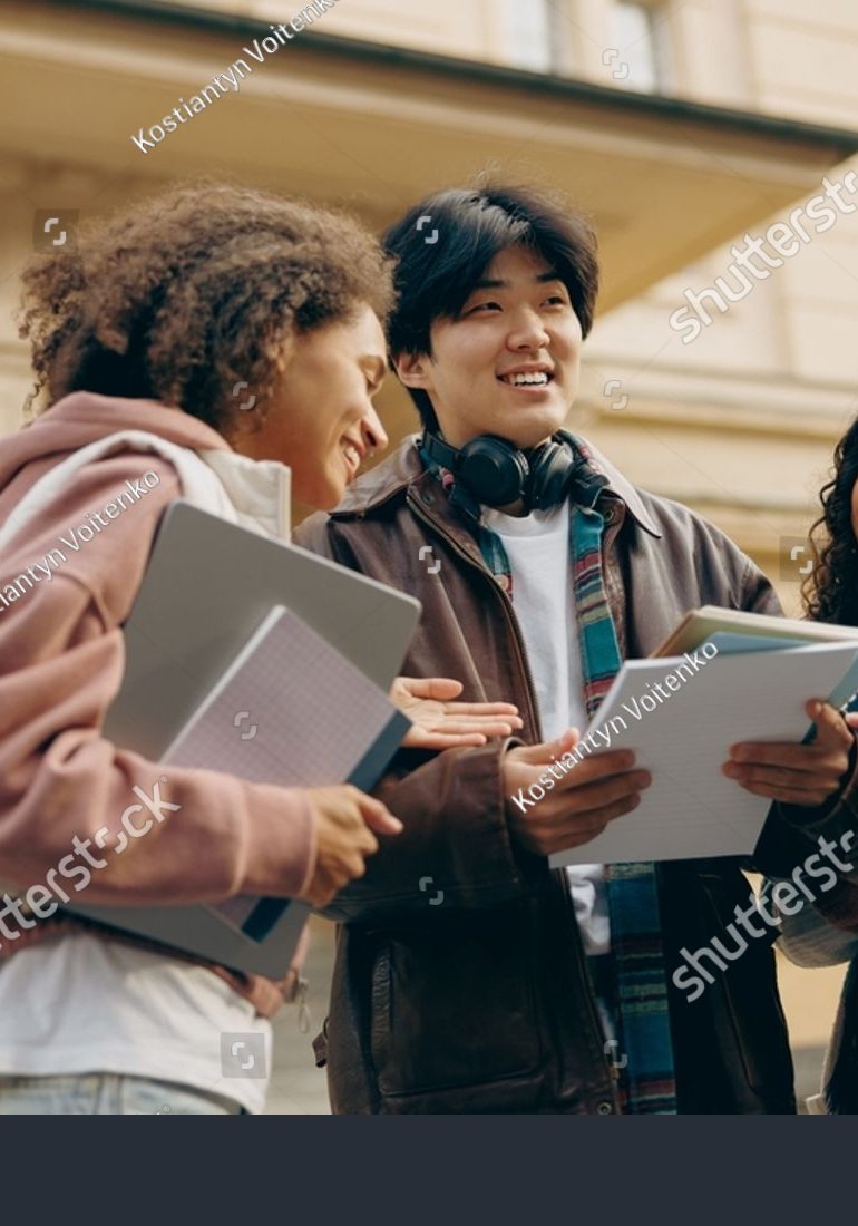 stock-photo-young-students-talking-and-laughing-together-outdoor-standing-near-campus-and-holding-books-2402854211